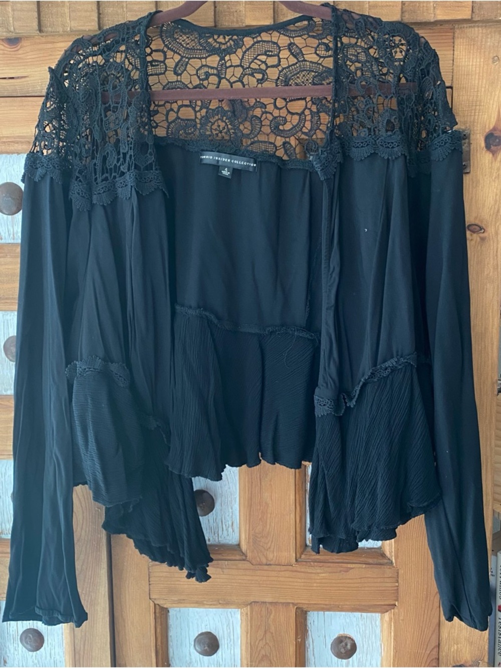 Cropped black lace / crochet cover up jacket with ruffled bottom